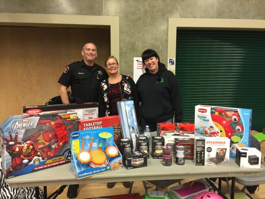 Volunteers and Rancho Cordova Police Department representatives are pictured with toys at the 2014 Christmas in Cordova.